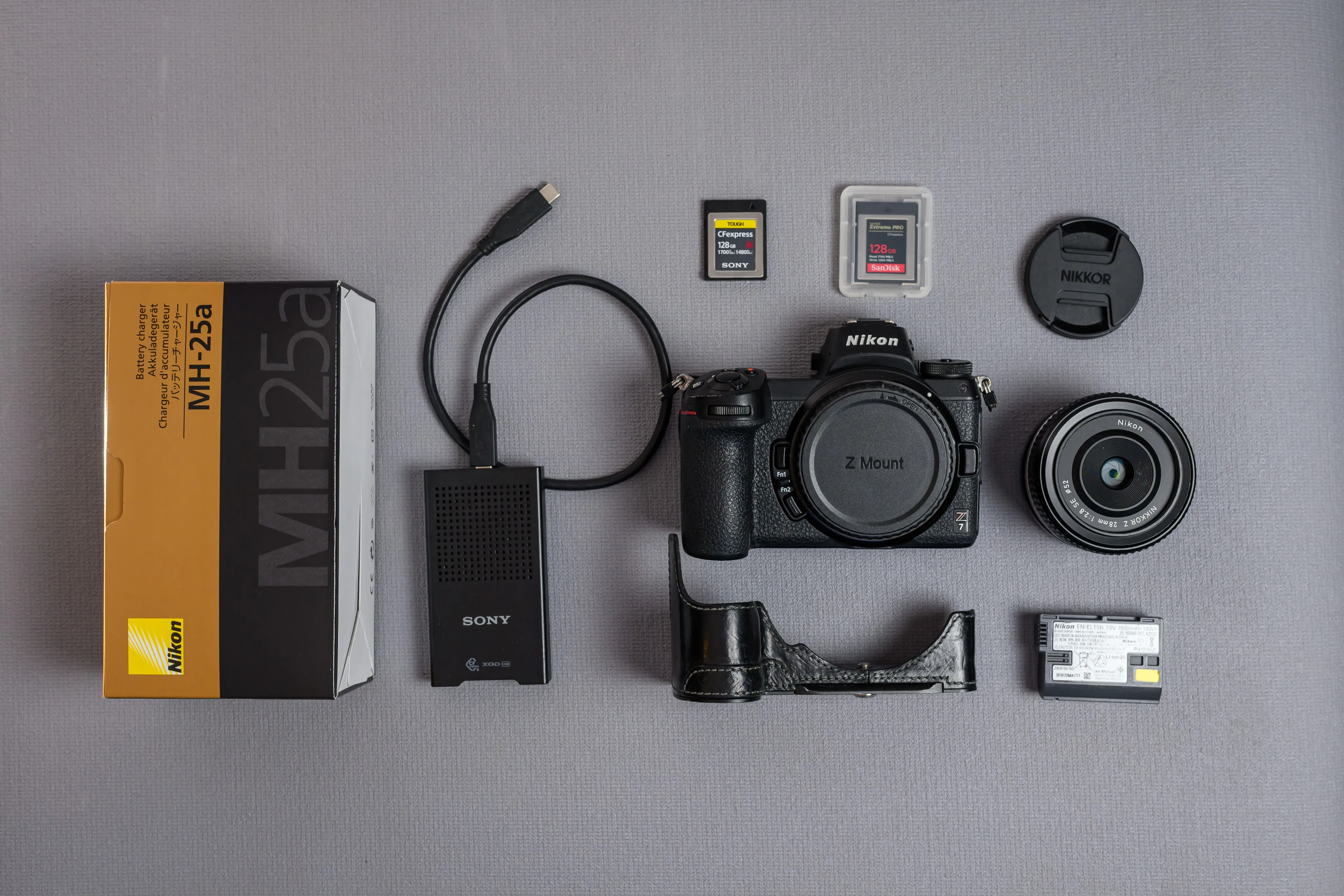 A camera body and accessories arranged on a gray surface