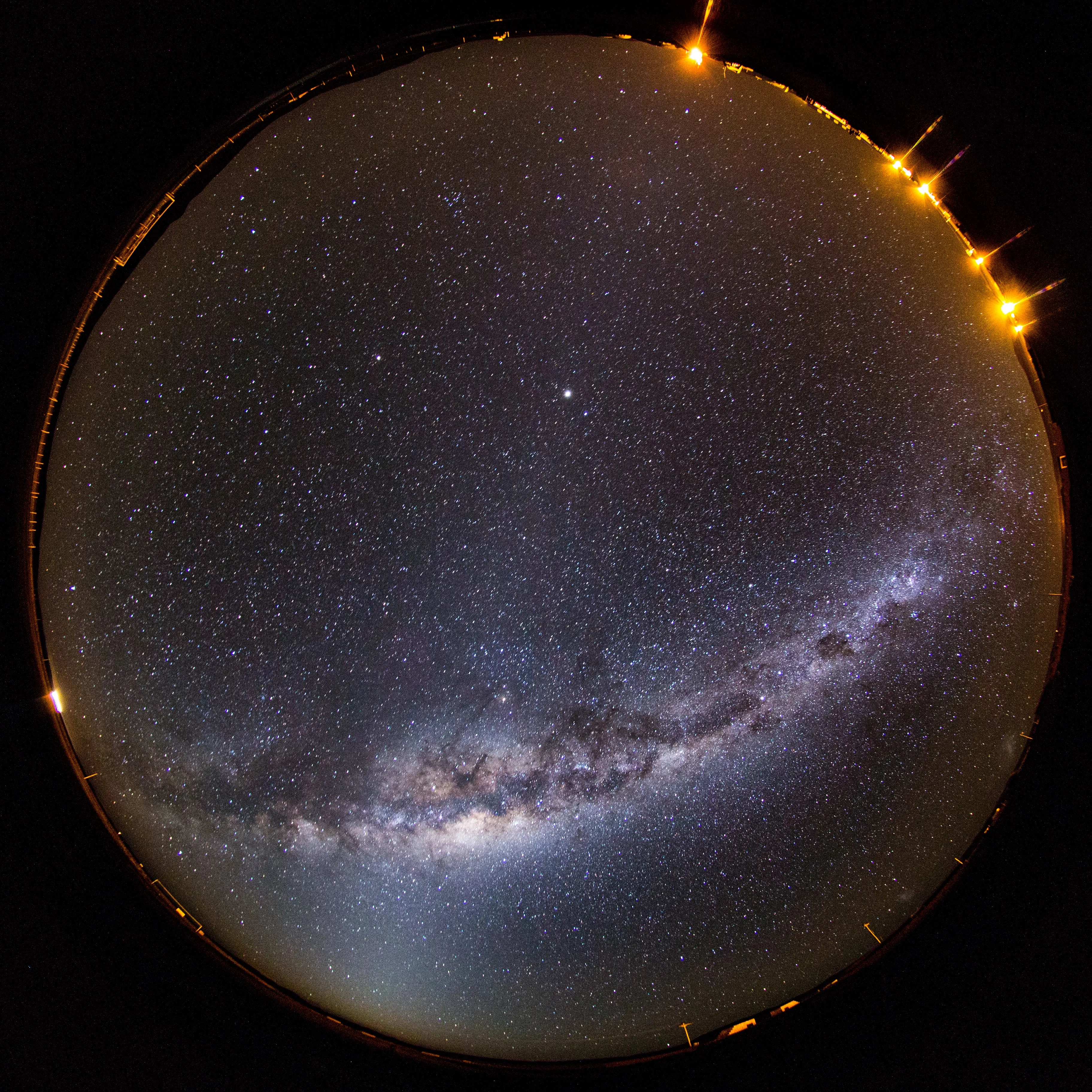 A fisheye view of the Milky Way arching across the night sky