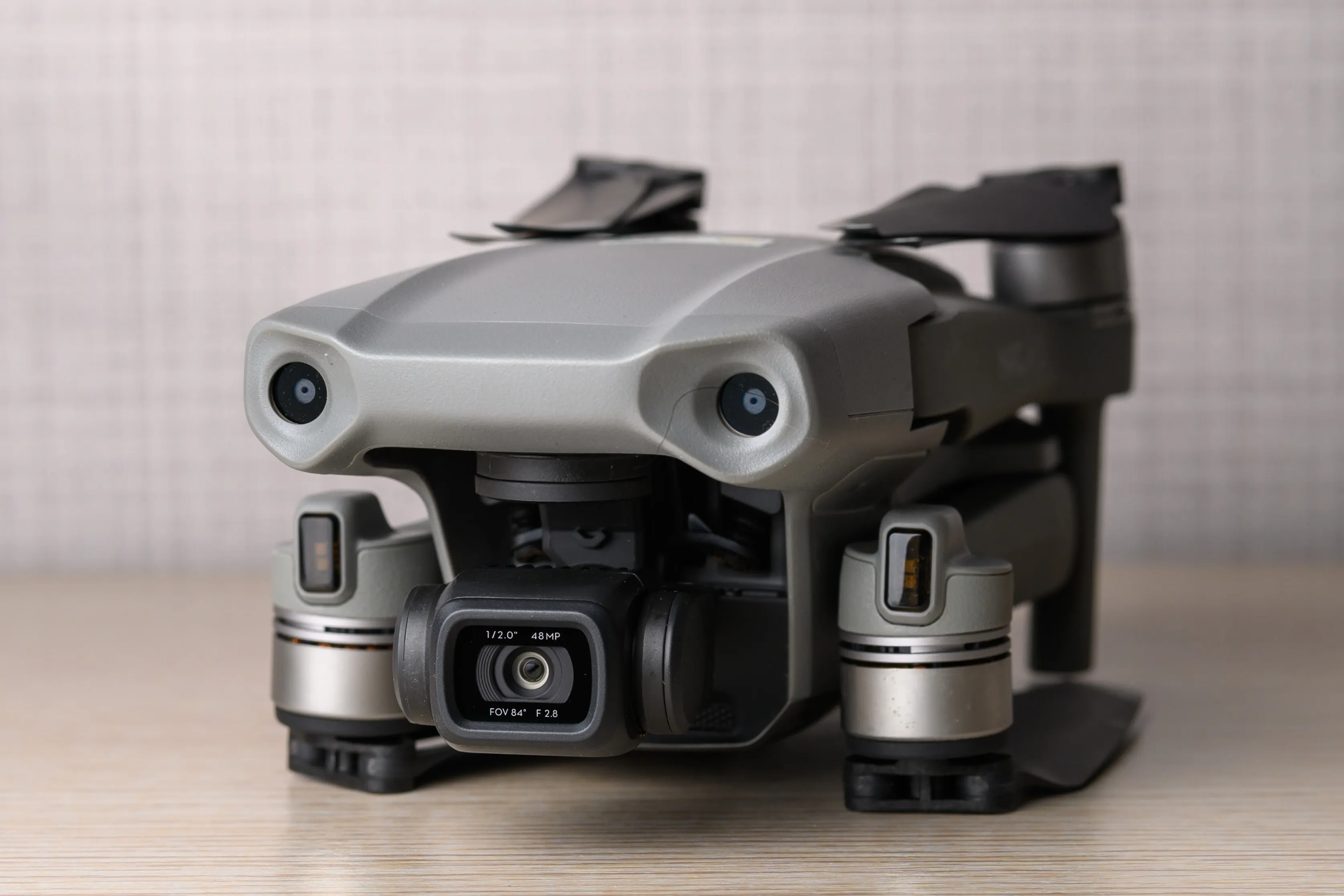 The front of a folded drone with its camera and sensors visible