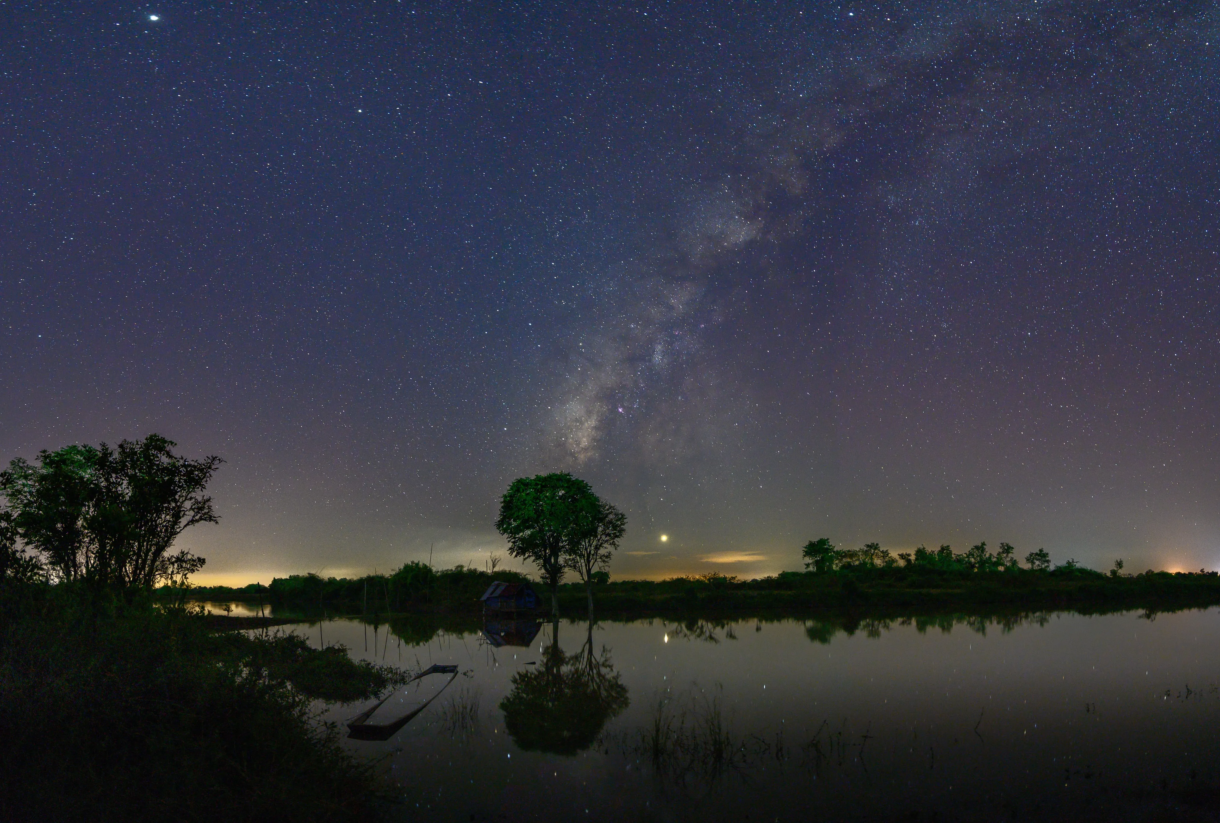 The Milky Way reflected in still wetland water at night