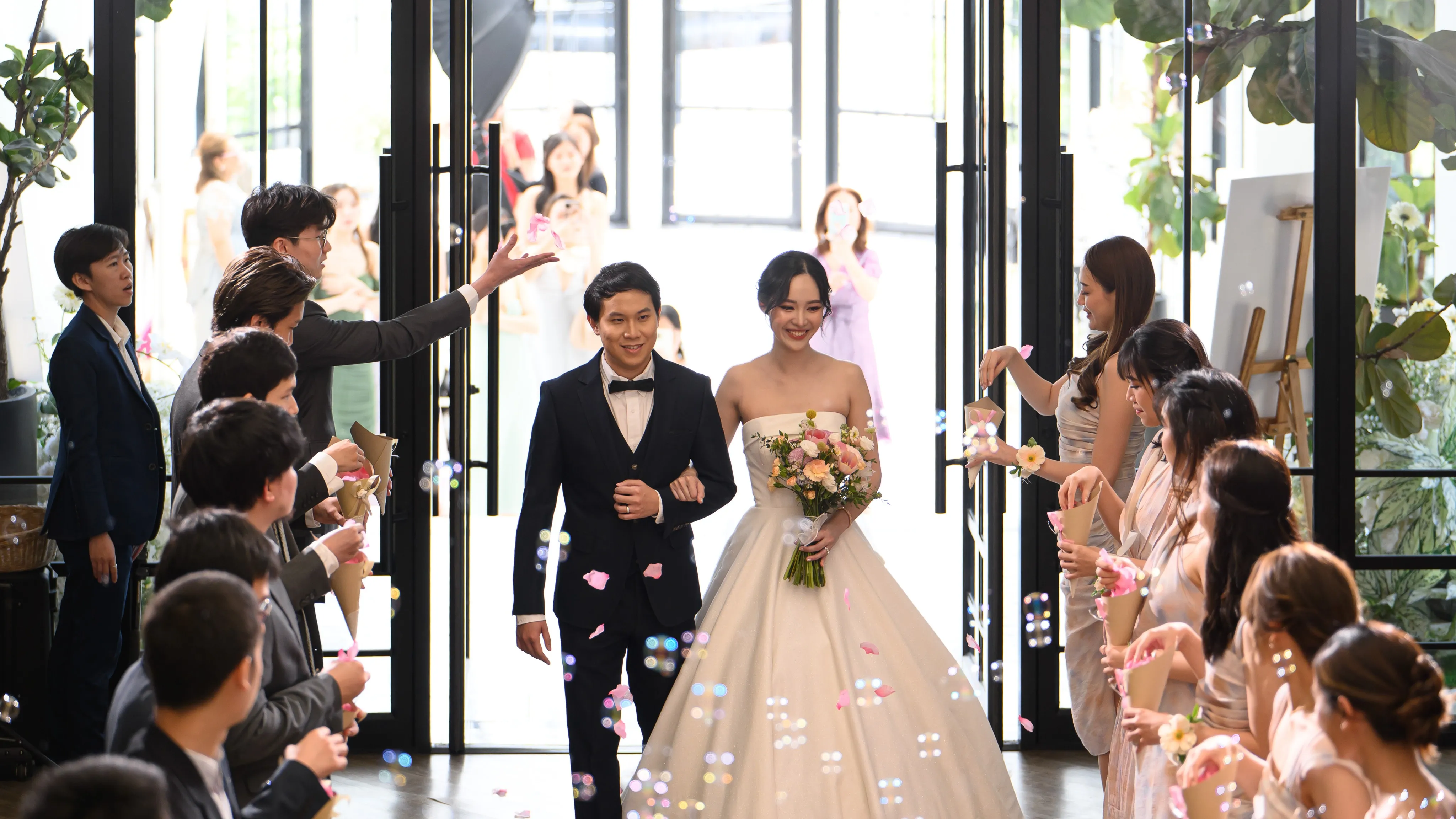 A couple entering their wedding reception through confetti