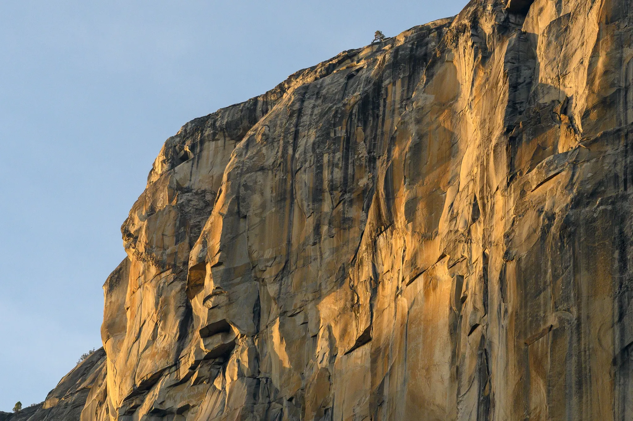 Sunlit cliff face showing layers of warm rock