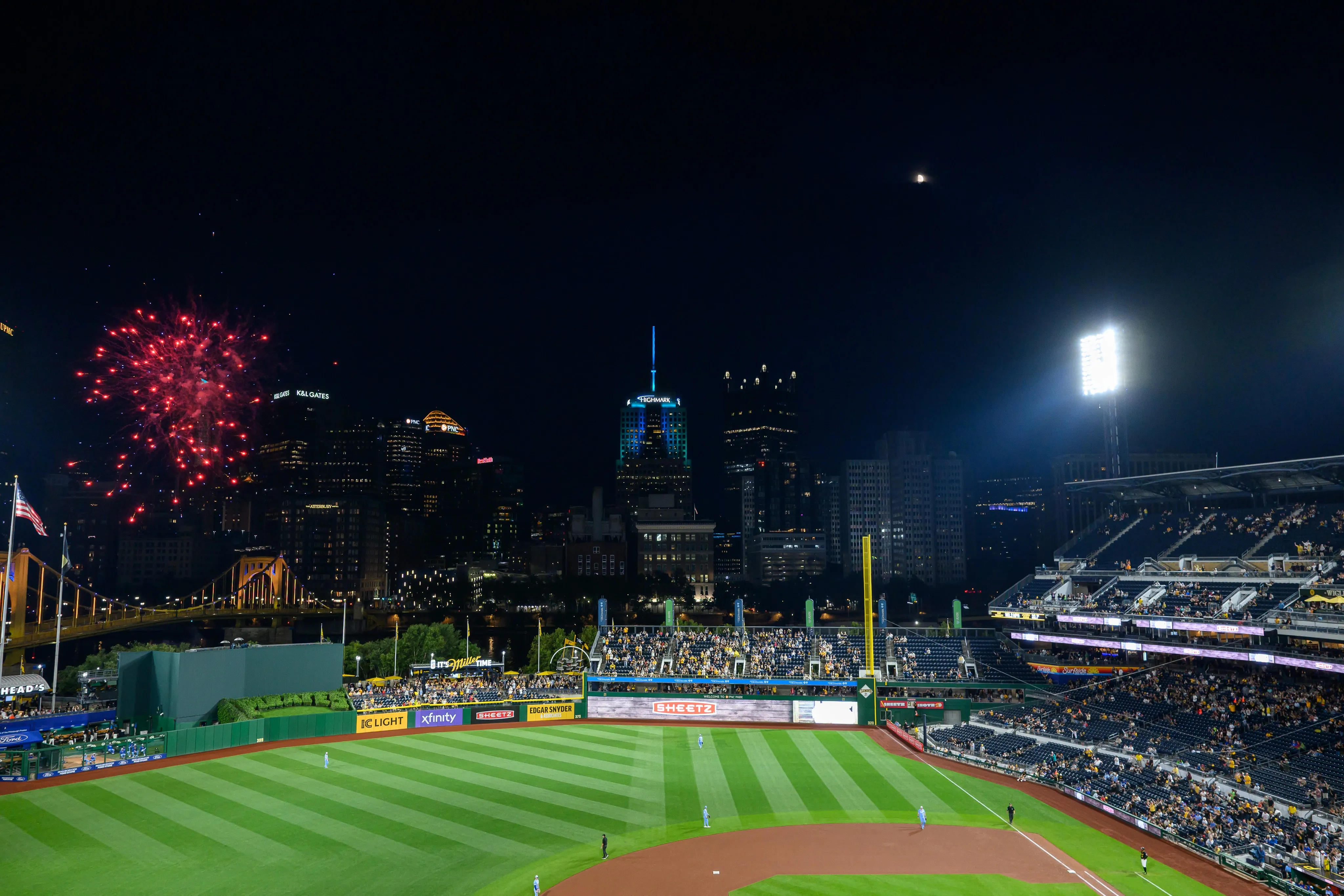PNC Park at night with fireworks over Pittsburgh's downtown skyline