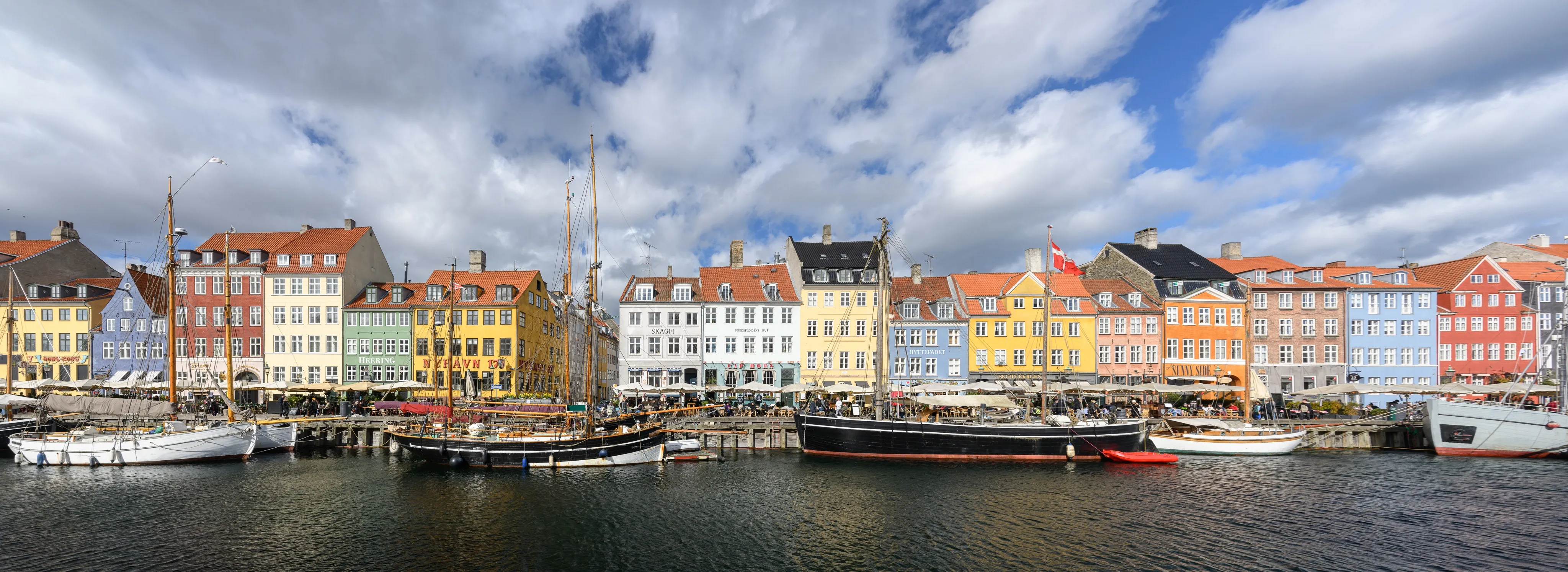 Colorful waterfront houses and boats along a historic harbor