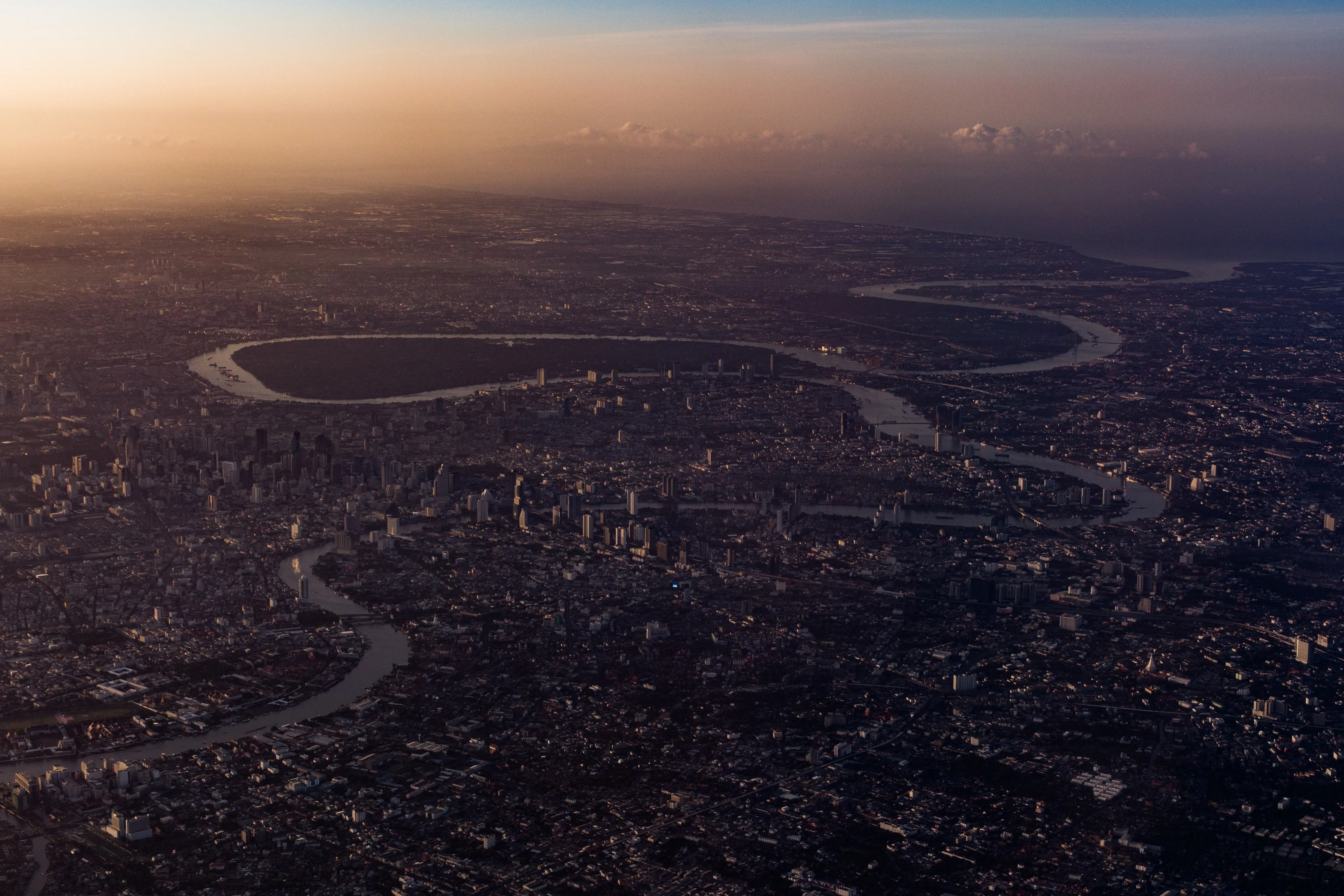 An aerial view from a commercial flight of the Chao Phraya River estuary at dusk.