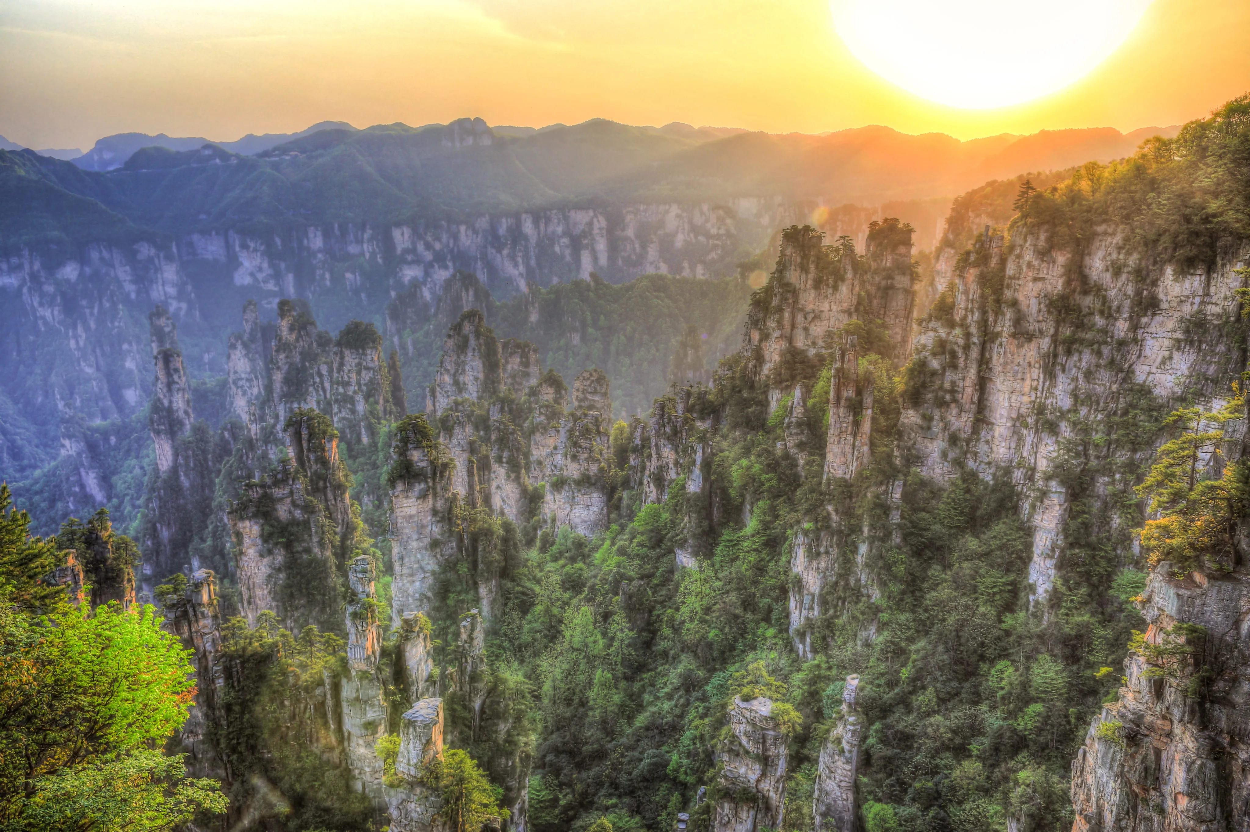 Layered karst mountain peaks glowing at sunset