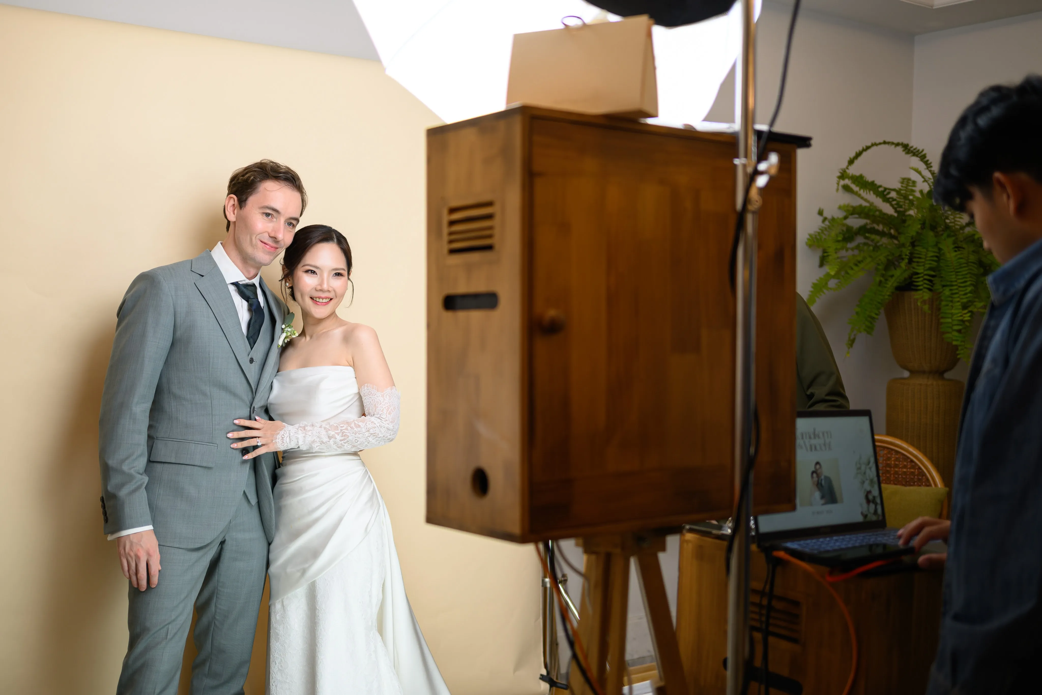 A couple embracing beside a wooden cabinet