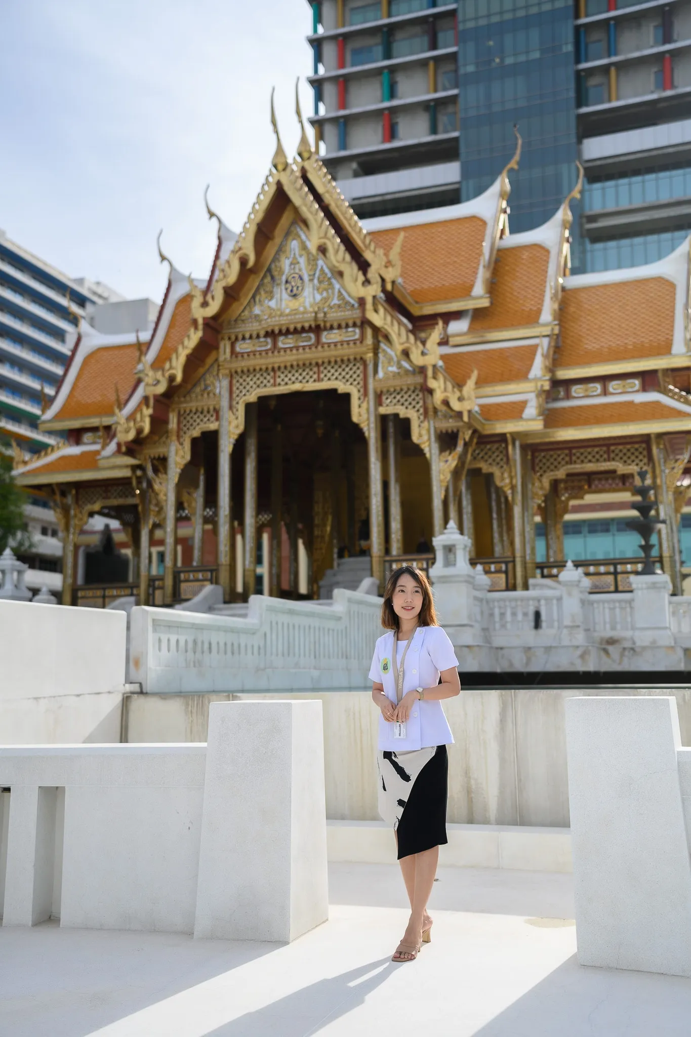 Woman posing in front of an ornate Thai temple