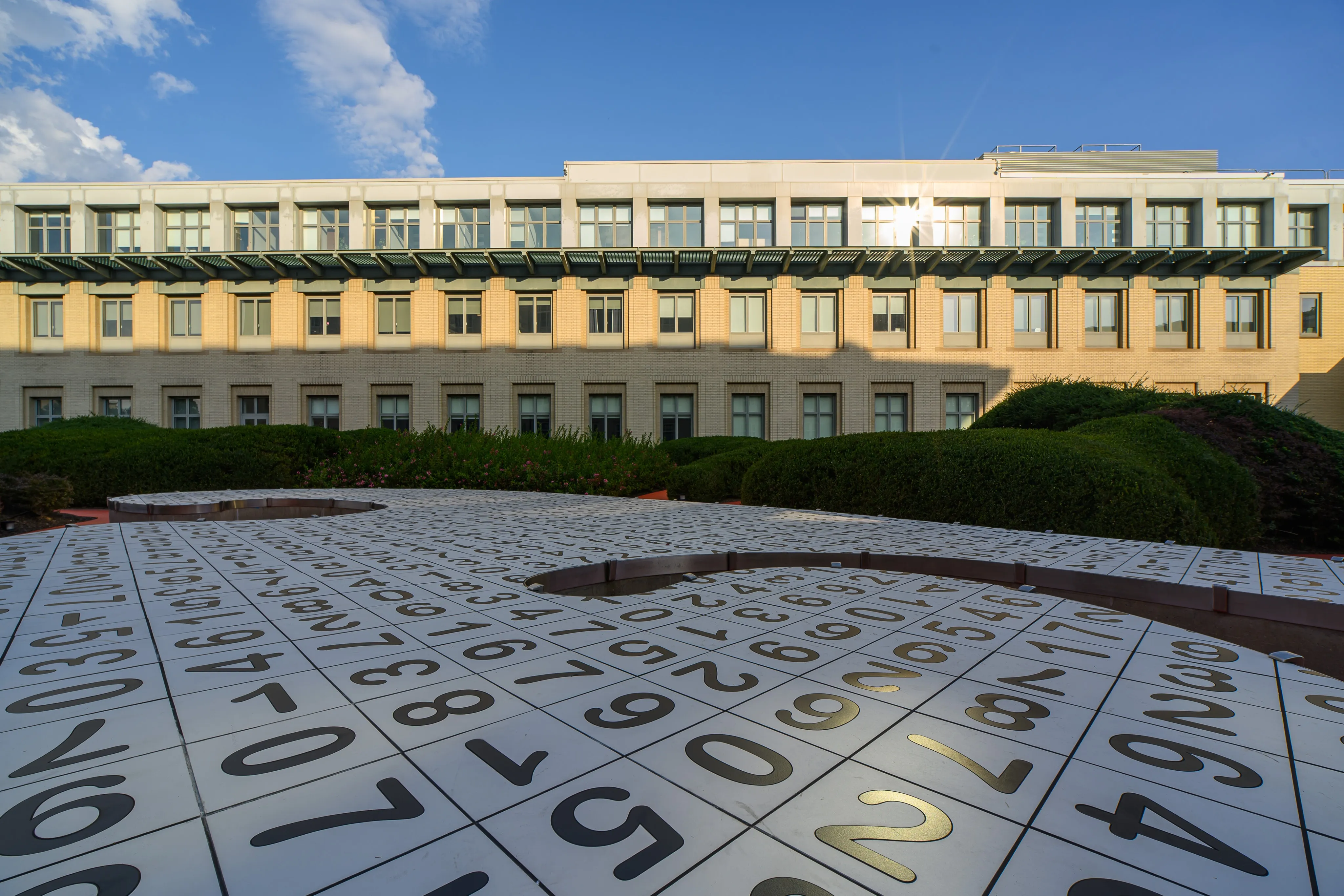 Symmetrical campus building facade lit by soft evening light.