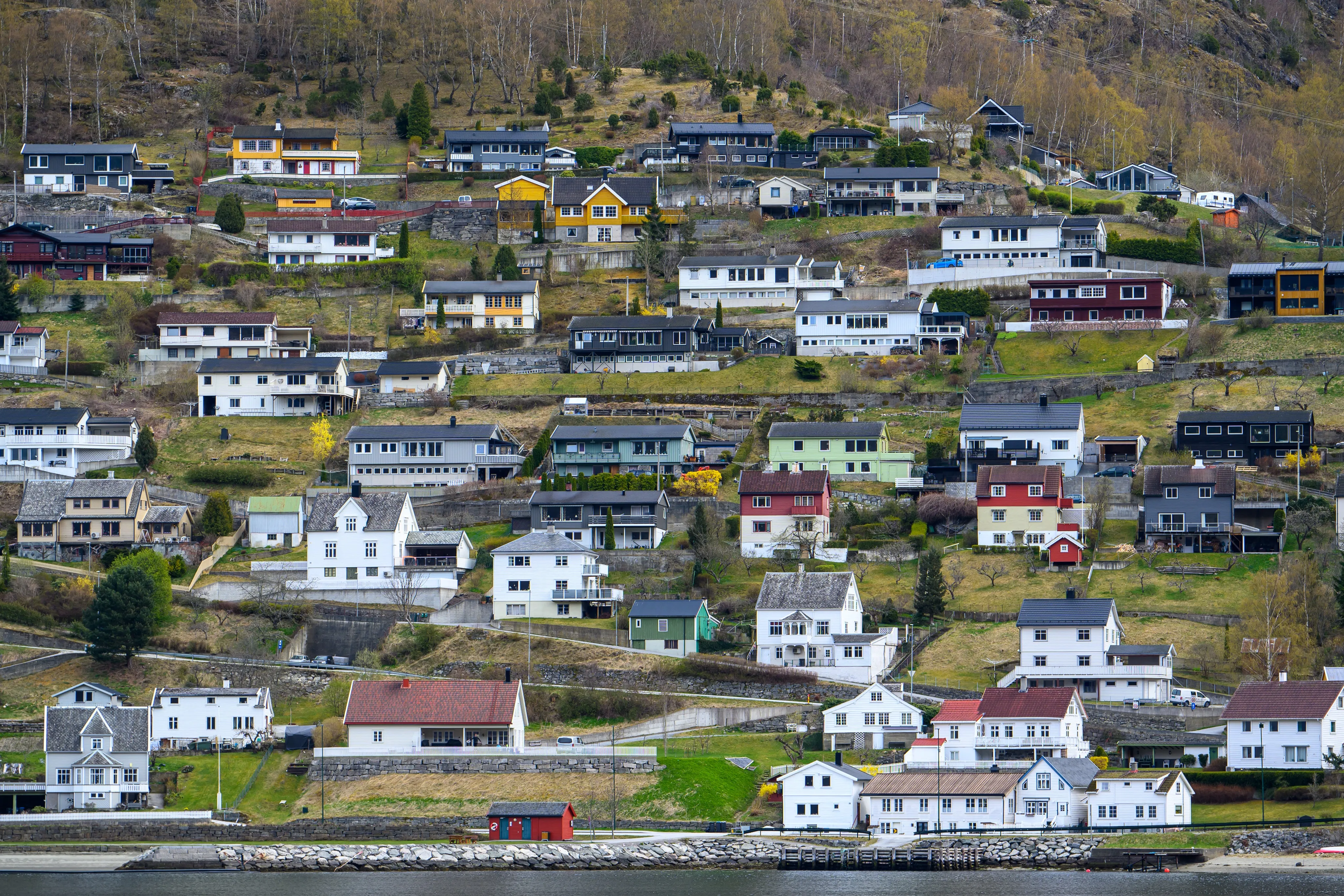 Colorful hillside homes below snow-streaked mountains