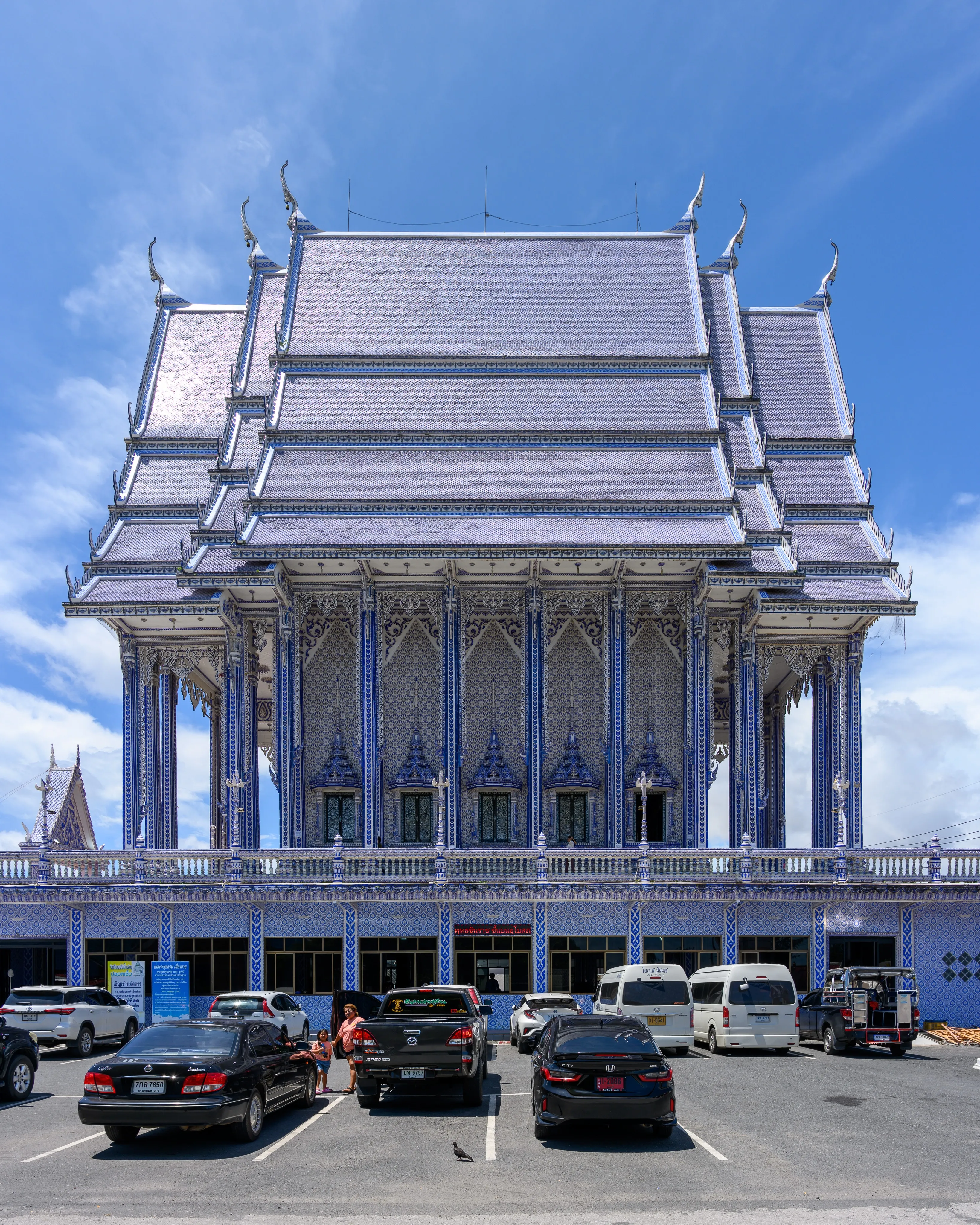 An ornate Thai temple building beneath a bright blue sky