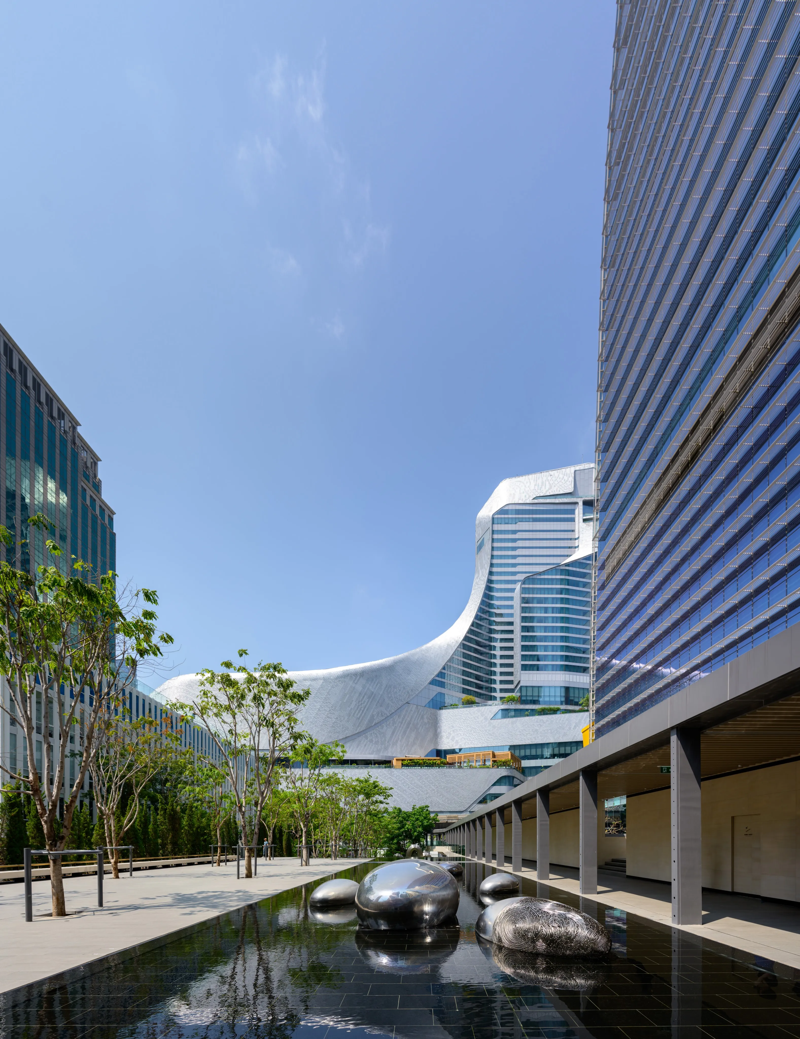 Modern towers rising above a landscaped urban courtyard