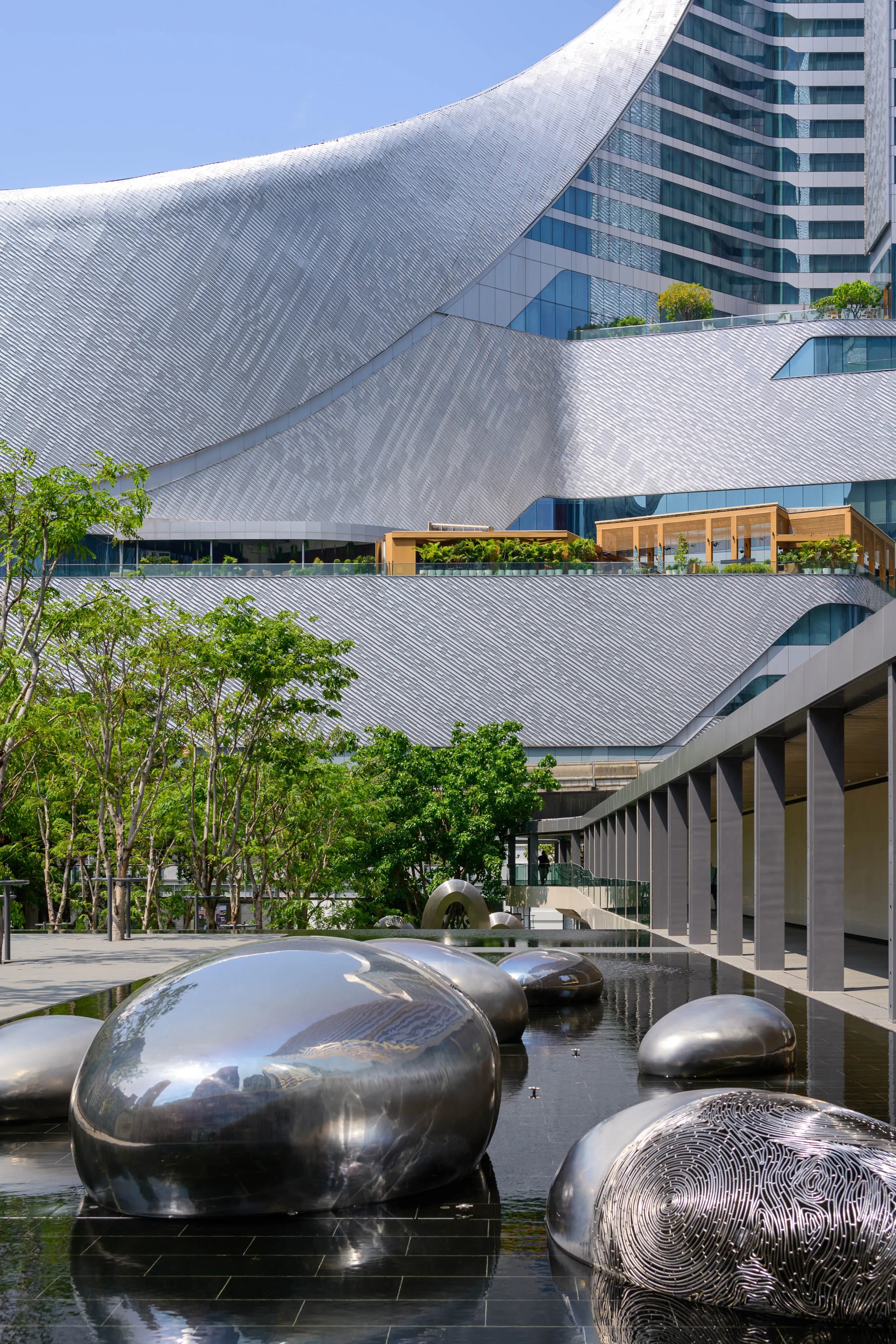 Curved modern architecture above polished sculptural forms