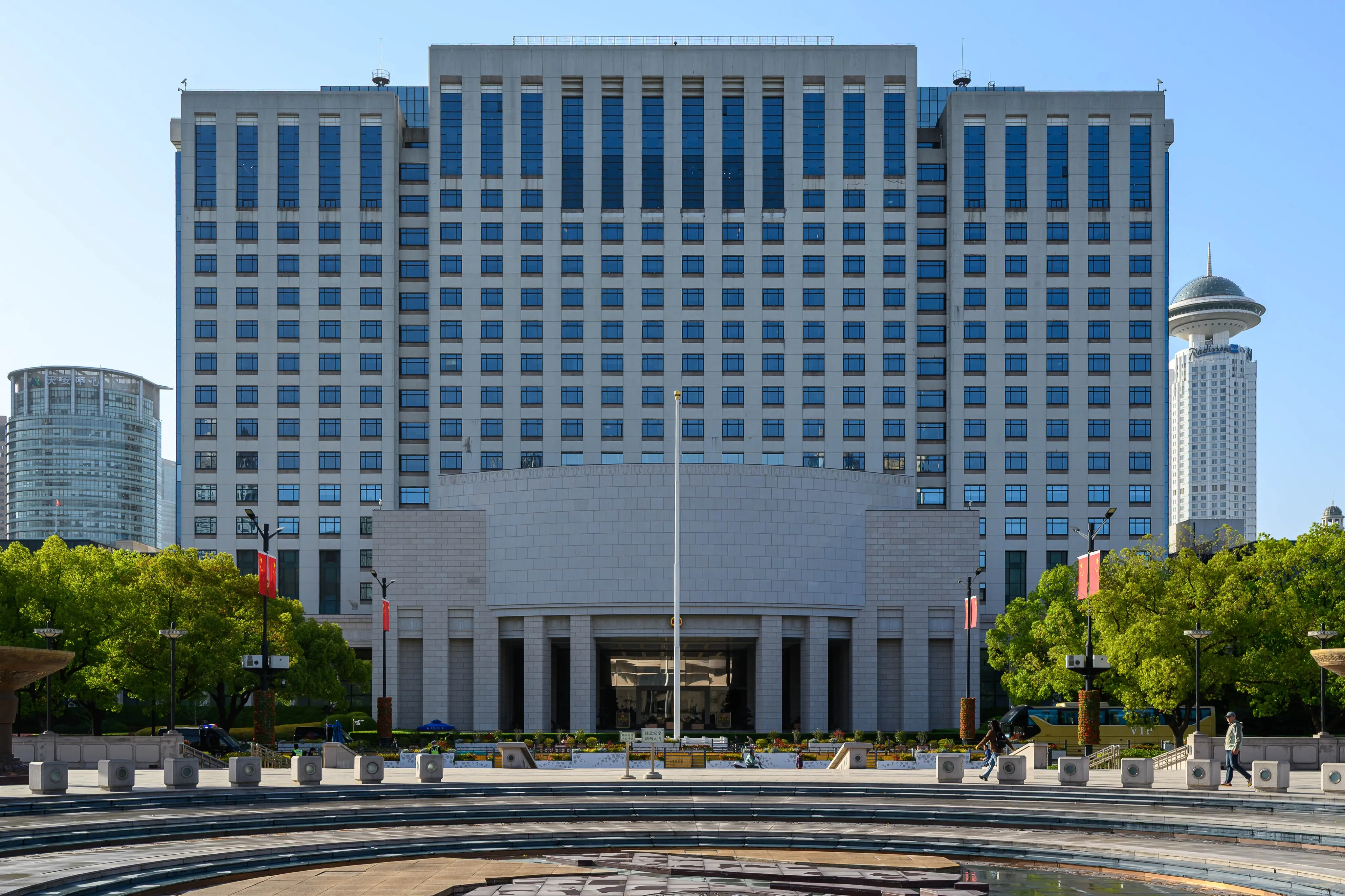 A broad modern building facing a paved plaza
