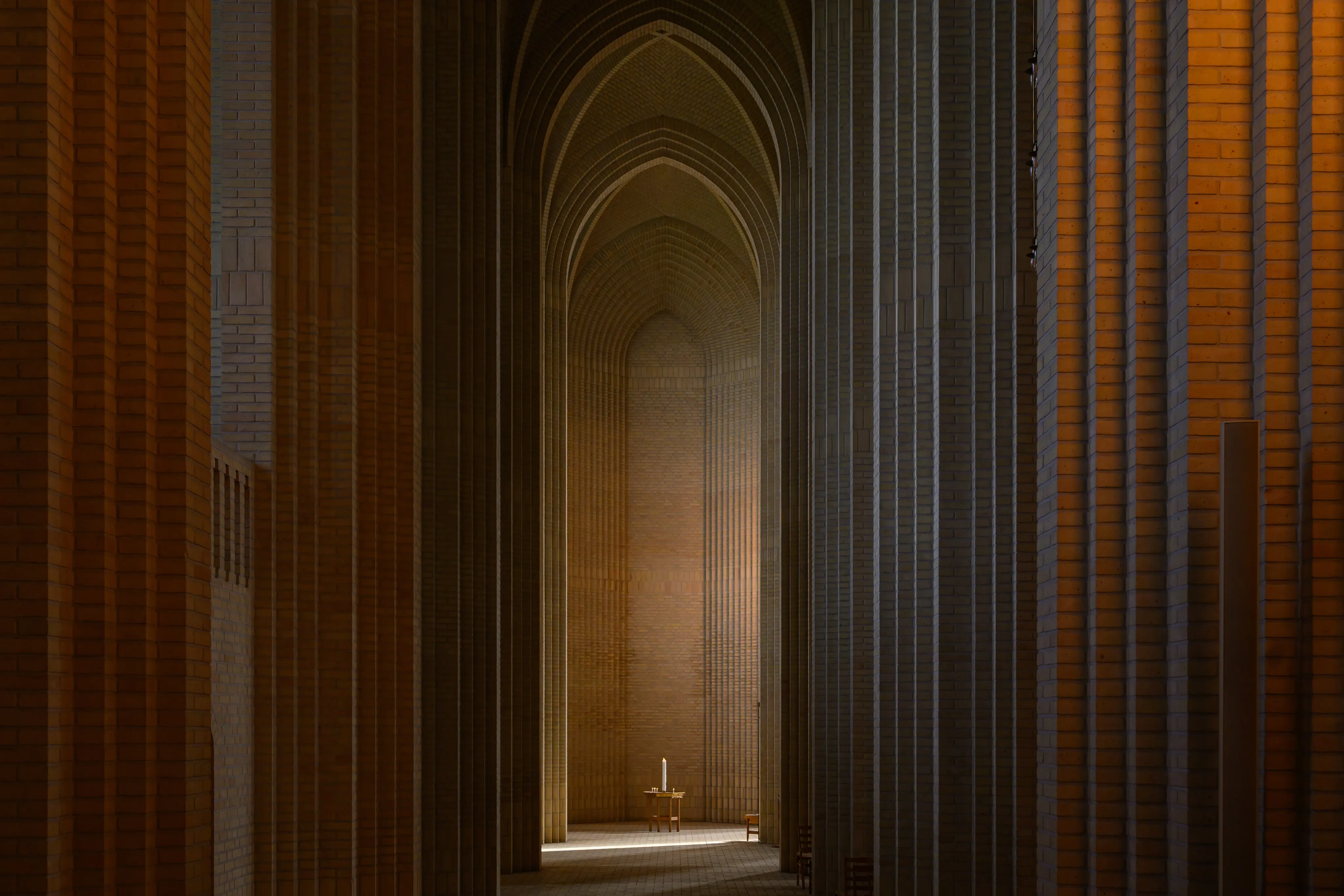 A warm brick church arcade with tall repeating arches