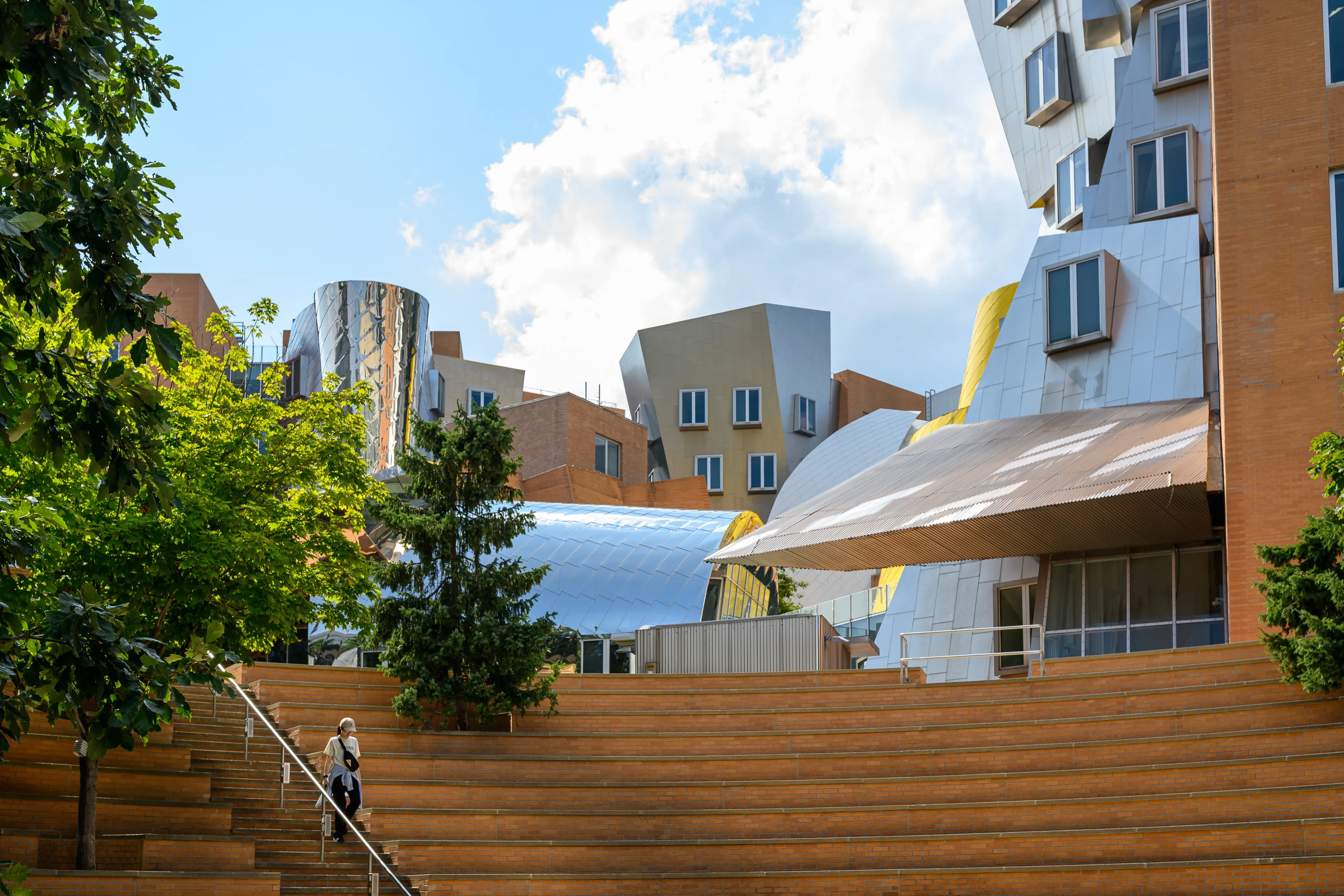 Angular campus buildings above a terraced courtyard at MIT