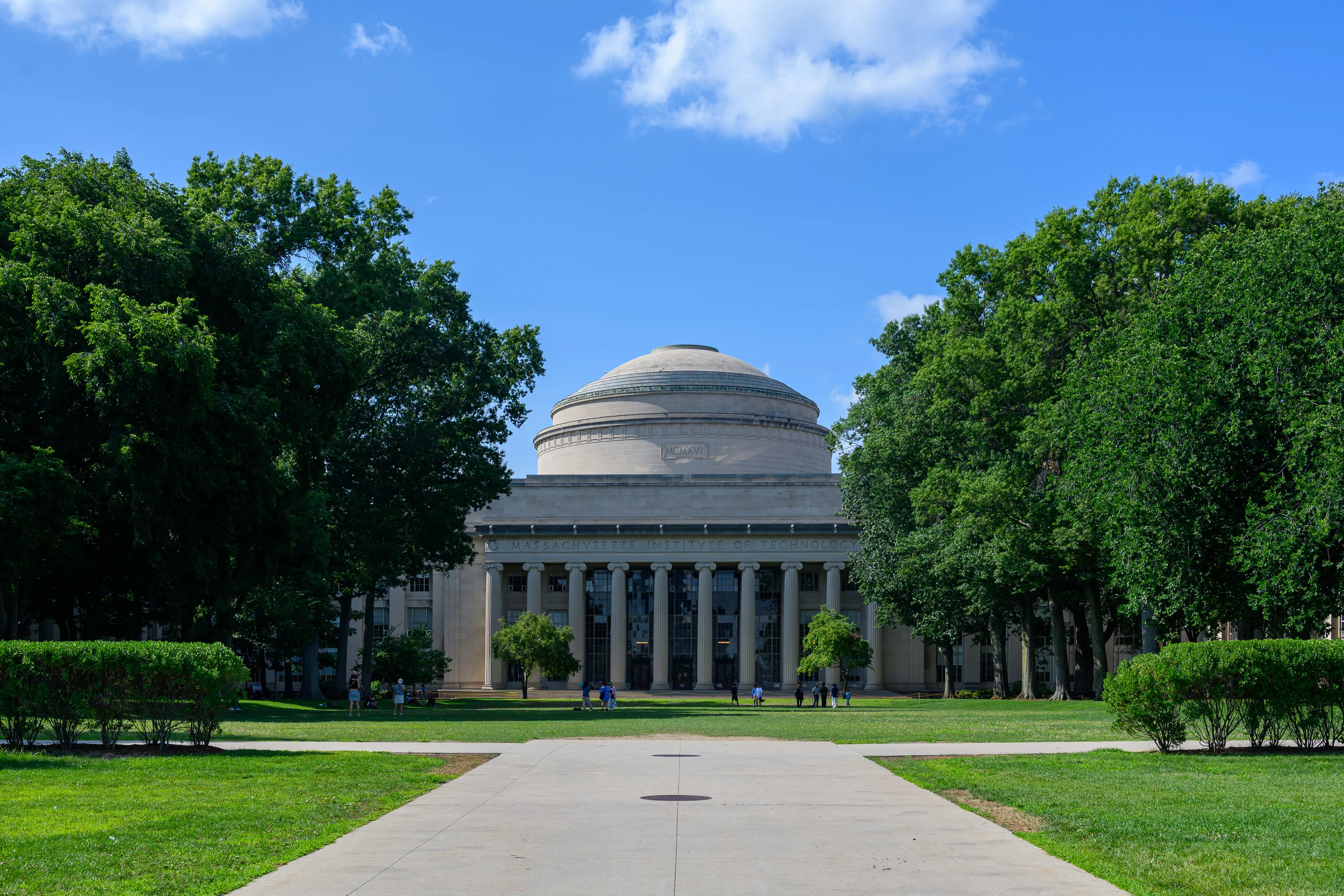 The domed Great Dome at MIT framed by trees and a broad lawn