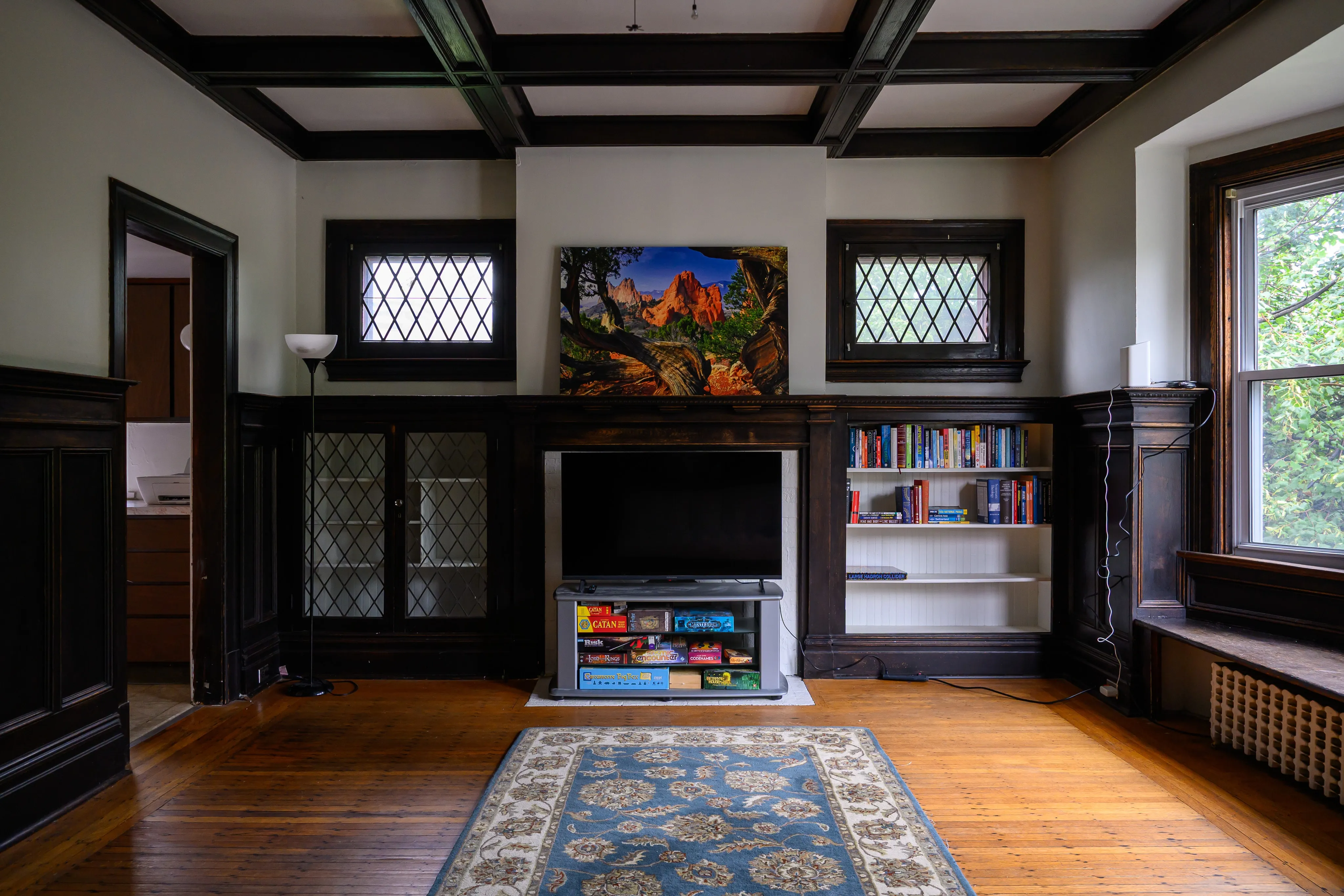 A traditional room with exposed wooden beams and a patterned rug