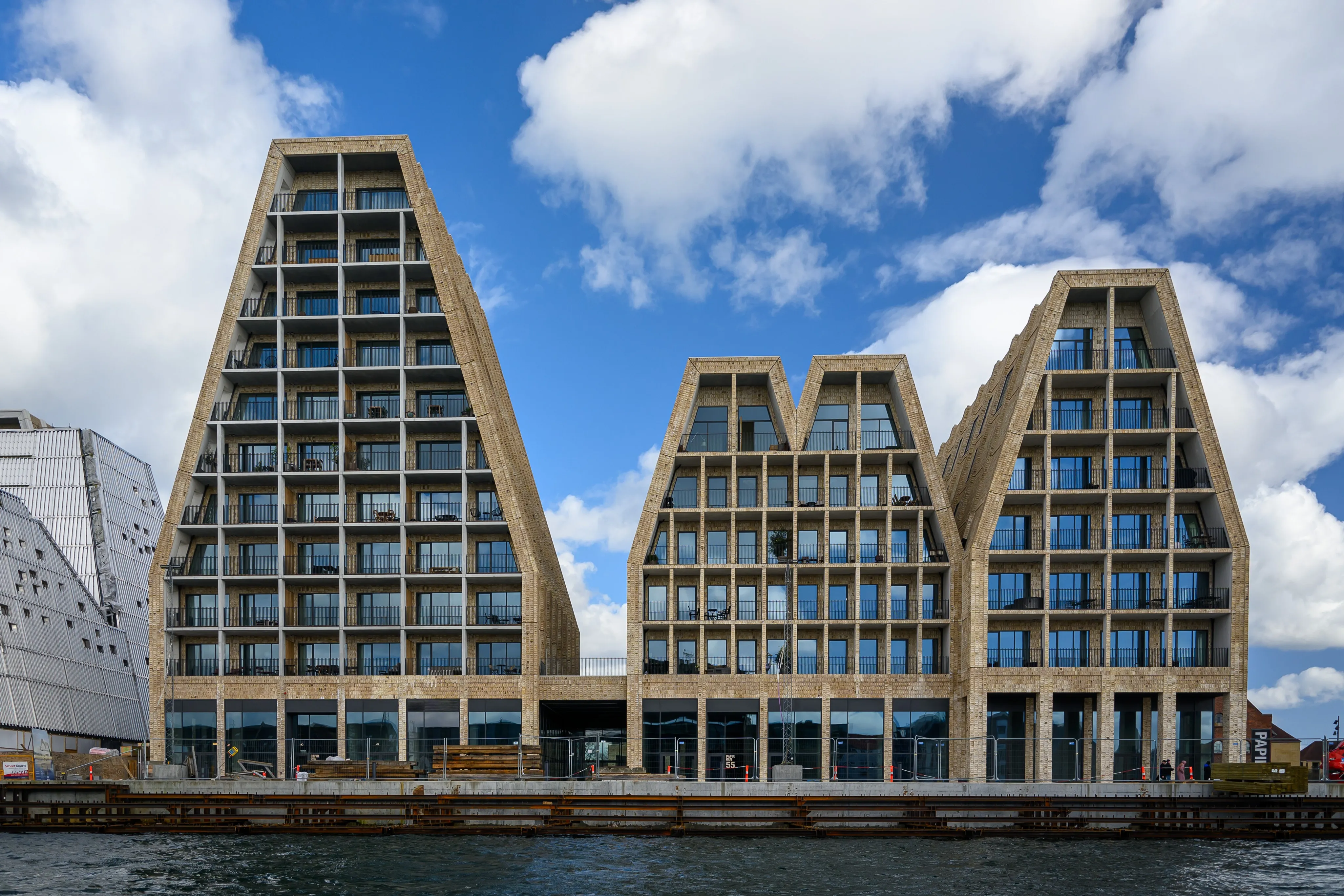 Modern peaked building facades beneath a blue sky
