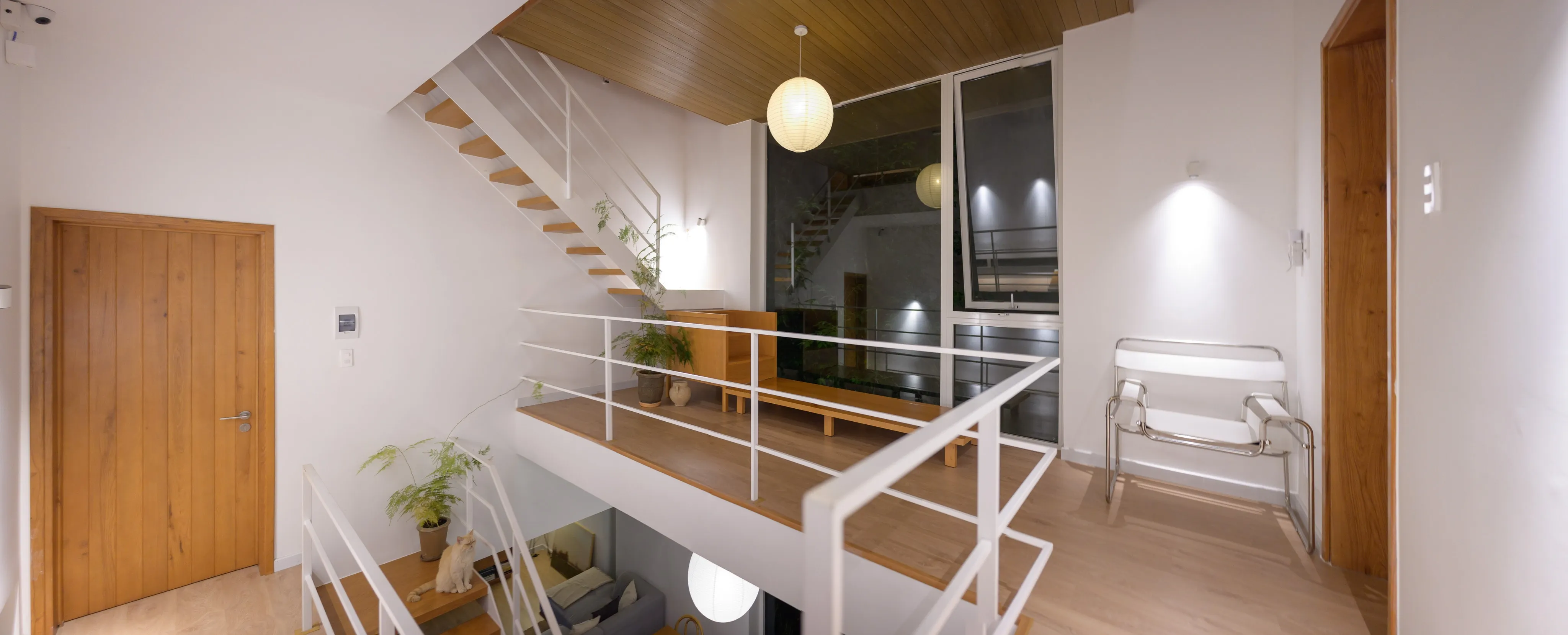 A modern interior with open levels and white railings