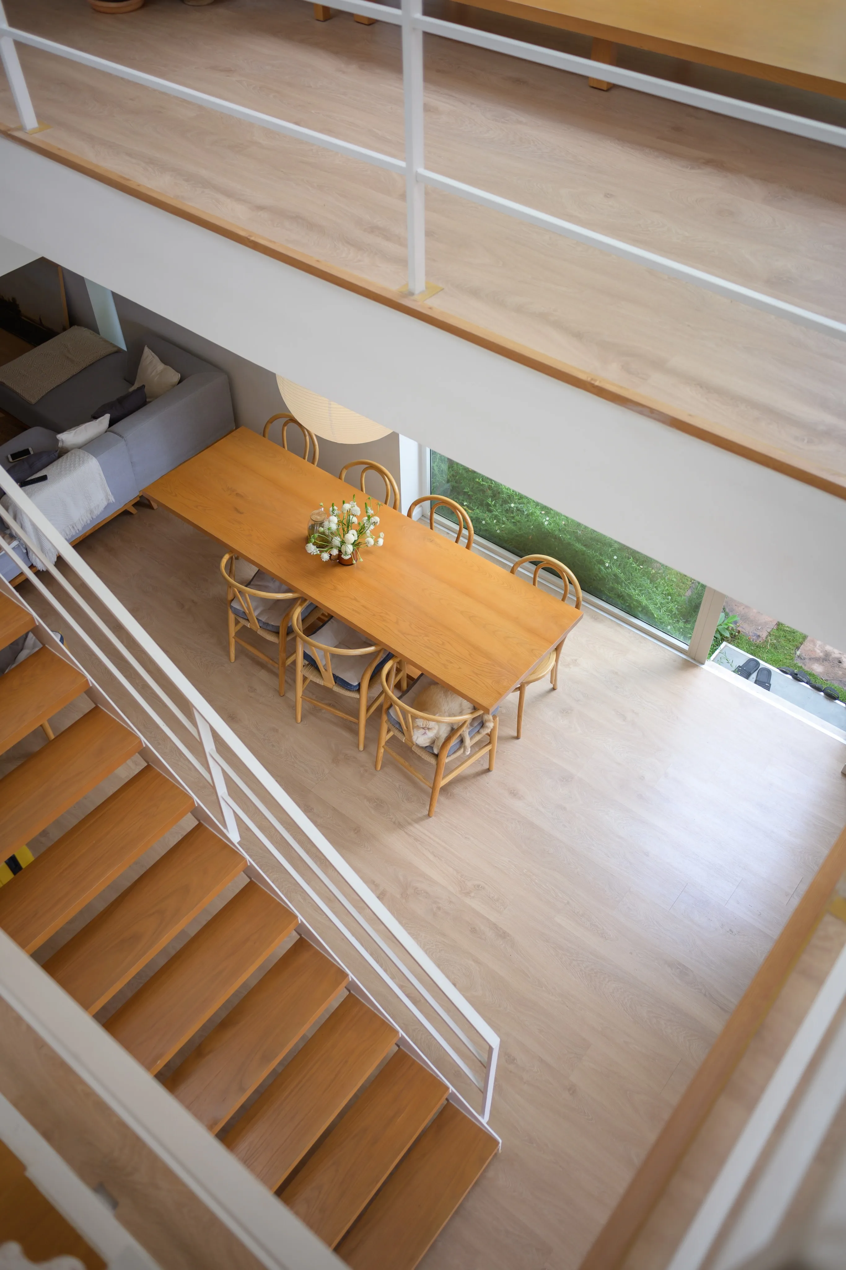 An overhead view of an open-plan interior with wooden floors