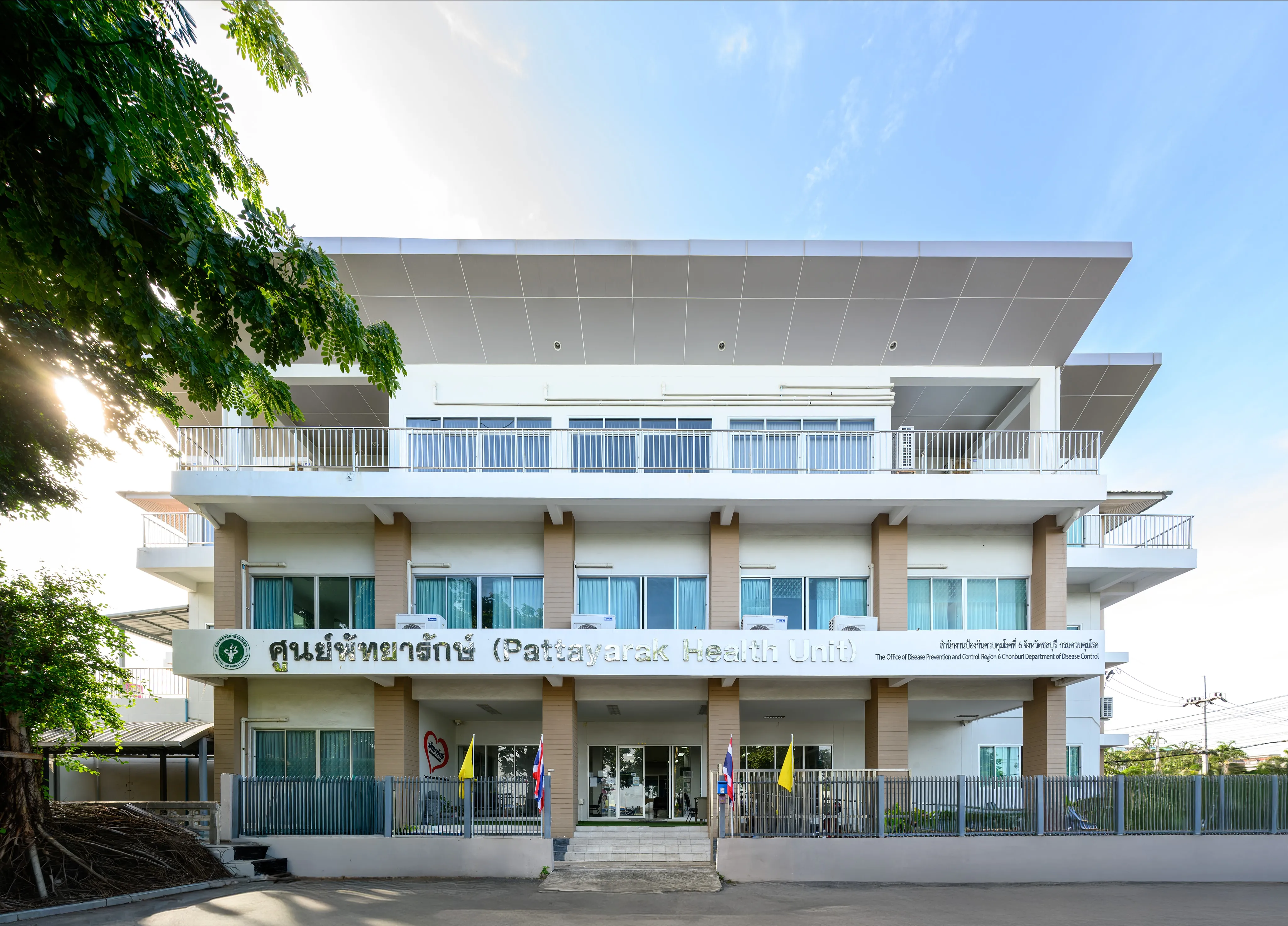 A white modern building framed by trees